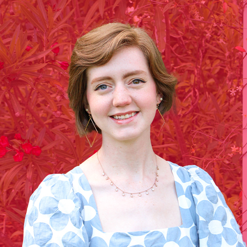 photo of a girl with heterochromia in a flower blouse with red background